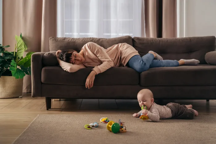 tired woman with an infant