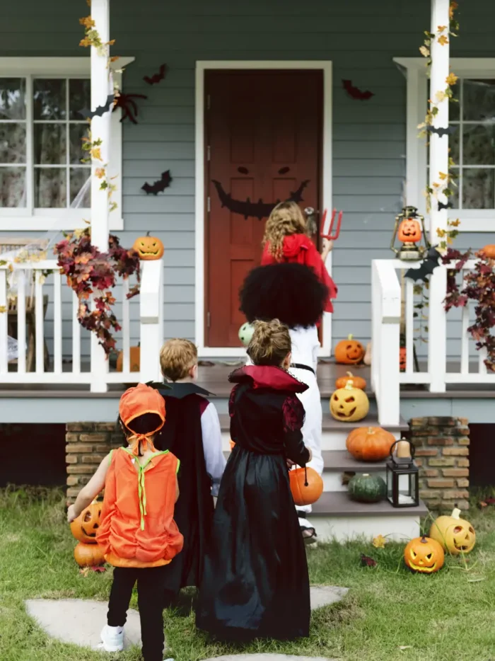children in costume going trick or treating on Halloween