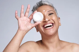 mature woman using coconut oil cream for wrinkles