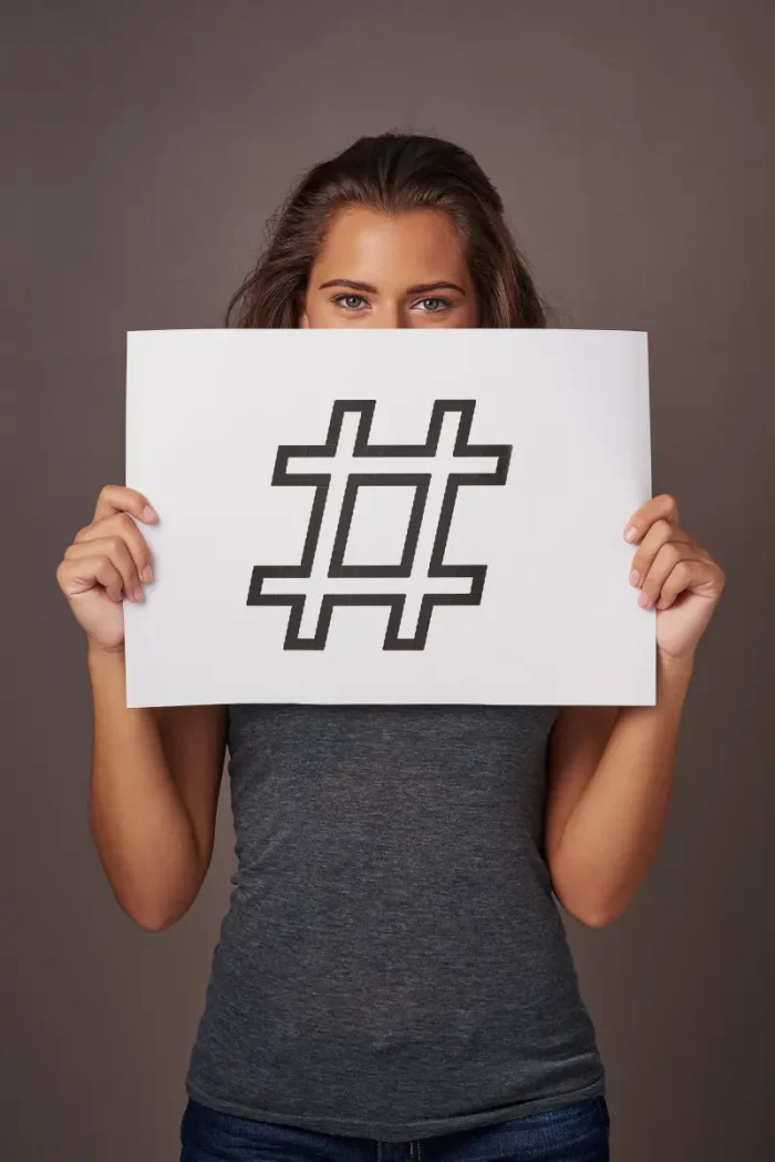 woman holding a hashtag sign